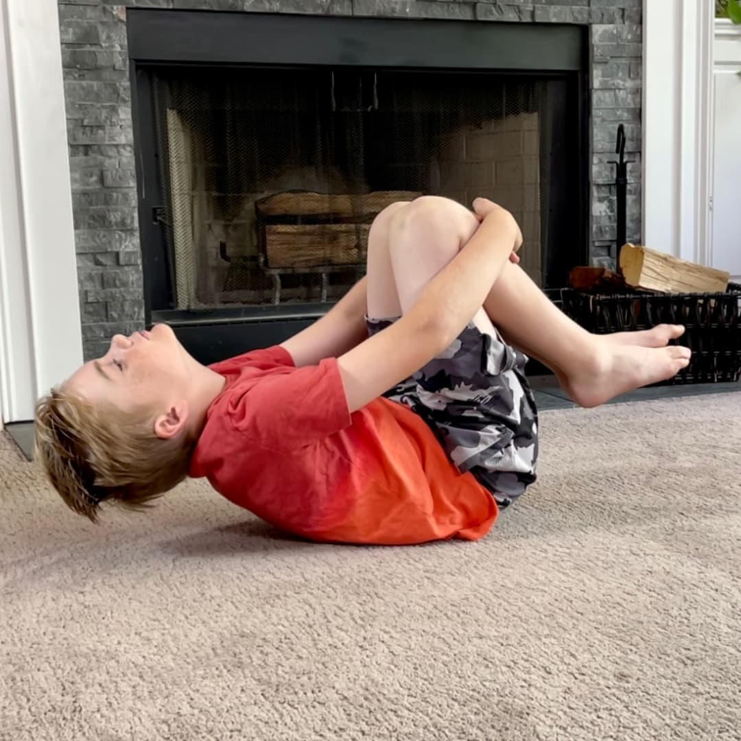Child doing a movement exercise at home