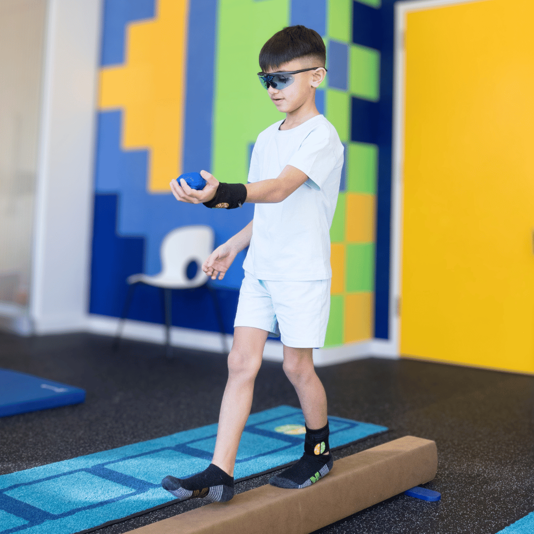 Child walking a balance beam during a Brain Balance session